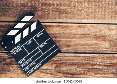 photo of movie clapper on wood background