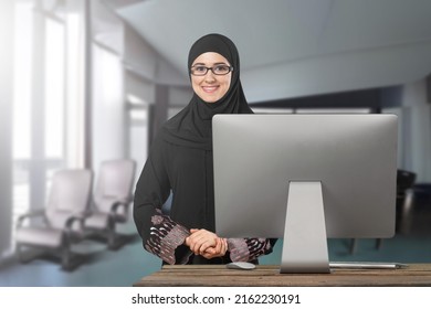Photo Of Muslim Businesswoman Wearing Hijab Works On Computer In Office.