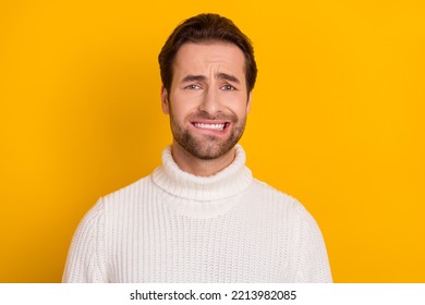 Photo Of Nervous Horrified Guy Bite Lip Anticipate Problems Wear White Knitted Sweater Isolated Yellow Color Background