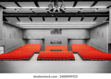 Photo of a new school theater, auditorium, with red and gray seats, chairs and new carpet in the aisle.	 - Powered by Shutterstock