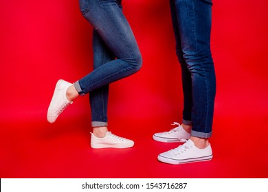 Photo of nice casual girlfriend boyfriend legs in jeans denim footwear white sneakers isolated vivid color background