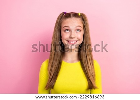 Photo of nice cute pleasant schoolgirl with ponytails dressed yellow long sleeve look empty space isolated on yellow color background