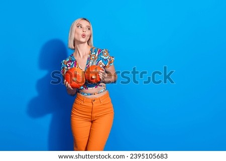 Photo of nice girl with bob hairdo dressed print shirt hold two squash look at grocery store empty space isolated on blue color background