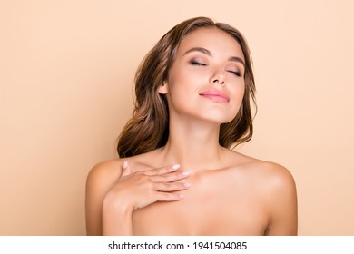 Photo of nice long hairdo optimistic lady without clothes hand neck closed eyes isolated on pastel beige color background