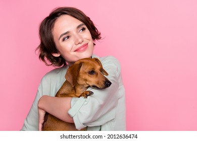 Photo of nice millennial lady hug dog look empty space wear grey green jacket isolated on pink color background - Powered by Shutterstock