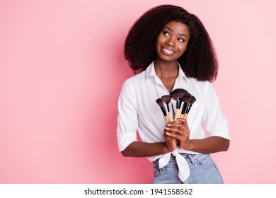 Photo Of Nice Optimistic Brunette Hairdo Lady Apply Make Up Look Empty Space Wear White Shirt Isolated On Pink Color Background