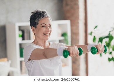 Photo of nice retired woman hold dumbbells exercises sportswear sport healthy lifestyle workout modern apartment home living room - Powered by Shutterstock