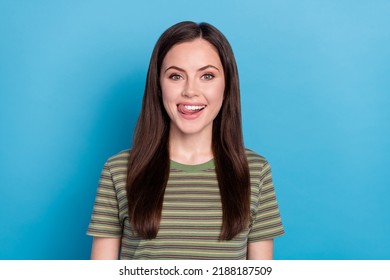 Photo of nice young brunette lady lick wear green t-shirt isolated on blue color background - Shutterstock ID 2188187509