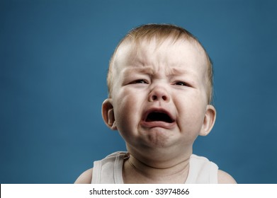 Photo of nine month baby crying, isolated