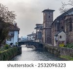 Photo of the Nive river and the church in the town of Saint Jean Pied de Port. France 