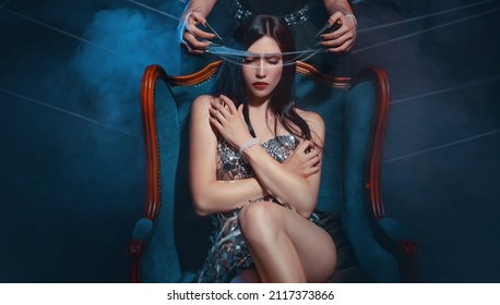 Photo with noise. Fantasy woman queen sitting on throne. Sexy dress. Gothic evil witch, envelops in cobwebs. demon vampire covers touches eyes face girl princess with spider's web hands with claws