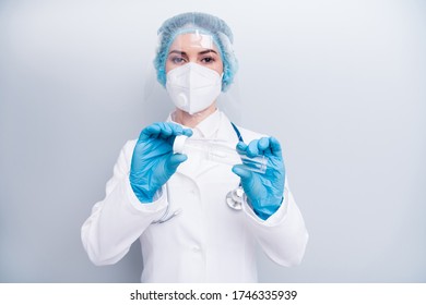 Photo of nurse lady doc hold test tube saliva collect equipment examining sick patient wear latex gloves mask coat facial plastic surgical cap isolated grey color background