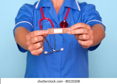 Photo Of A Nurse In Uniform Holding A Bandaid Sticky Plaster Towards Camera.