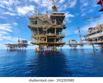 Photo of Oil and gas platform in day time with blue sky background.