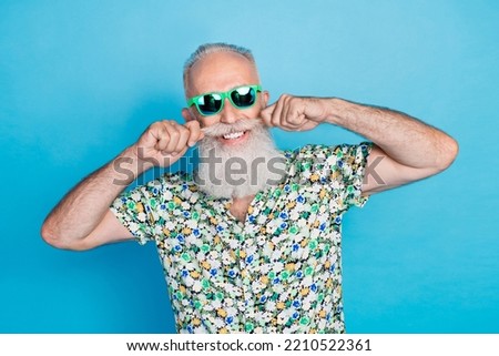 Photo of old age pensioner senior grandfather toothy smile touch his mustache metrosexual wear sunglass isolated on bright blue color background
