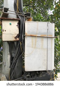 Photo Of Old Cable Box Mounted On Electricity Pole Near The Street