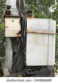 Photo Of Old Cable Box Mounted On Electricity Pole Near The Street