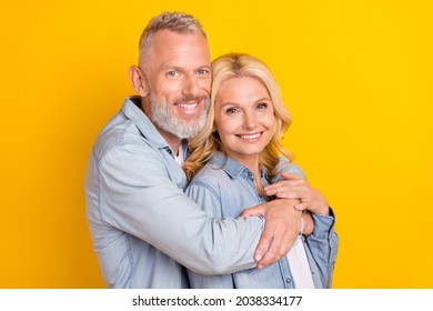 Photo Of Old Happy Positive Married Couple Embrace Good Mood Smile Isolated On Yellow Color Background