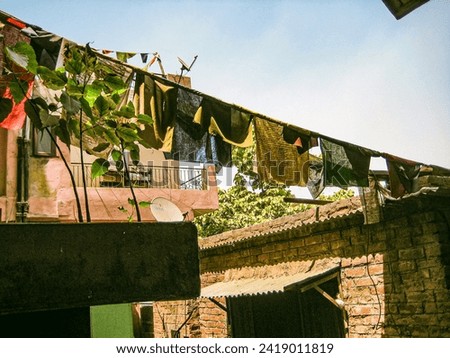 photo of old poor home in delhi with tibet flags and bathroom