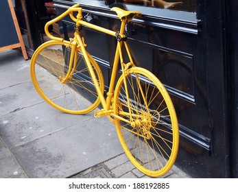 Photo Of Old Yellow Bike On The Window Of The Coffee Shop        