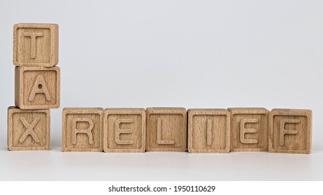 Photo On Tax Relief Theme. Wooden Cubes With The Words 