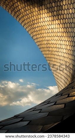 photo of one of the corners of the soumaya museum where you can appreciate its architecture and contrast in an abstract and charming design on a day of sun and clouds