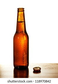Photo Of Open Beer Glass Bottle With Lid On The Table Isolated On White Background, Alcohol Beverage, Cold Bubbles Drink, Amber Ale, Brew Pub, German Beer Festival, Tavern, Fresh Lager