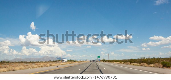 Photo of an open road with divided highway and\
traffic near Phoenix Arizona.\
