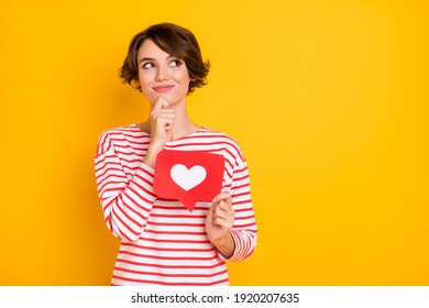 Photo of optimistic brunette lady hold like look empty space wear red shirt isolated on orange color background - Shutterstock ID 1920207635