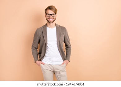 Photo of optimistic nice blond hair man wear spectacles grey jacket isolated on beige color background - Powered by Shutterstock