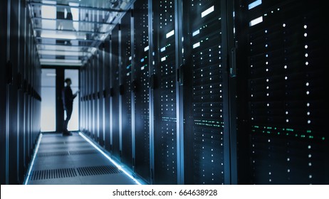 Photo of Out of Focus IT Technician Turning on Data Server. - Shutterstock ID 664638928