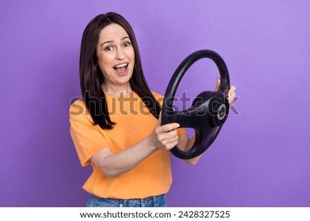 Photo of overjoyed brunette hair funny woman in yellow t shirt drive new volkswagen auto fast speed isolated on violet color background