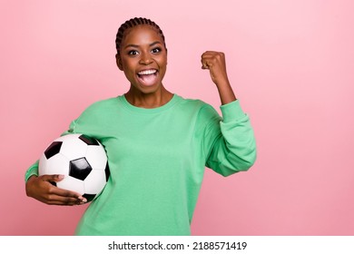 Photo of overjoyed delighted person raise fist celebrate triumph hold ball isolated on pink color background - Powered by Shutterstock