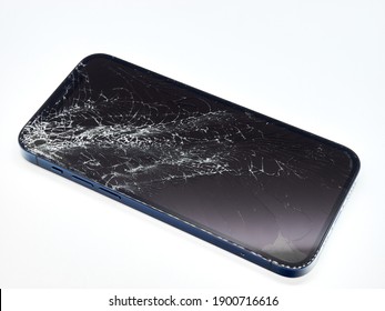 Photo of pacific blue Apple iPhone 12 Pro with broken damaged display. Modern smartphone with damaged glass screen on white background. Device needs repair.