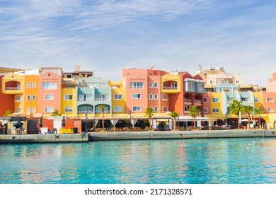 Photo Of Panoramic Seascape With Multicolored Houses On The Seafront Of Egypt, Hurghada. Colorful Marina Promenade Street From Red Sea With Part Of The Azure Surface Of The Sea