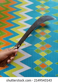 Photo of parang or machete indonesian traditional weapon and gricultural tools with wooden handle and colorful background