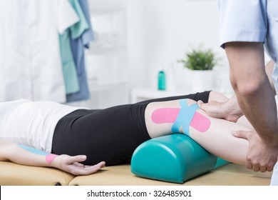 Photo Of Patient With Elastic Therapeutic Tape During Exercises