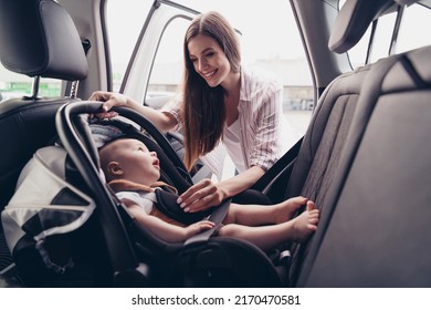 Photo of peaceful satisfied mommy cute charming toddler sitting safety chair auto spend weekend together