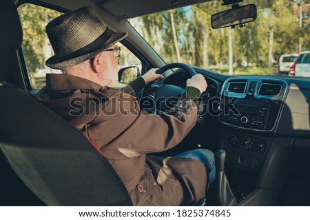 Photo of pensioner grandpa drive sit seat look roadway hold steering wheel wear brown jacket cap specs inside car