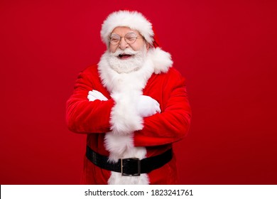 Photo of pensioner grandpa grey beard folded hands self-assured loud laugh listen kid story wear x-mas costume leather belt gloves coat spectacles headwear isolated red color background - Powered by Shutterstock