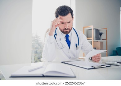 Photo of pensive doctor guy read check list medical service in white hospital room - Powered by Shutterstock