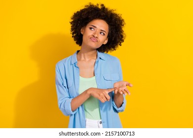 Photo of pensive uncertain suspicious lady count fingers look empty space wear denim shirt isolated yellow color background