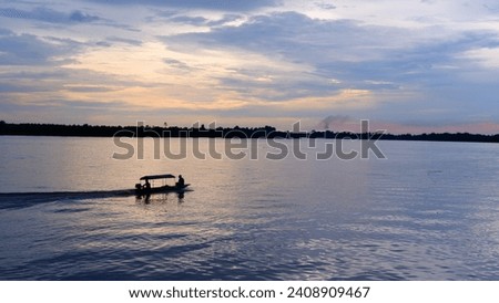 photo of people riding a boat on the river