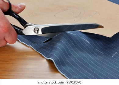 Photo Of A Piece Of Pinstripe Material Being Cut Around A Bespoke Template