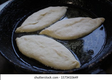  Photo Pies In The Pan.the Semi-finished Product Is Fried.dishes Cast Iron, Black.