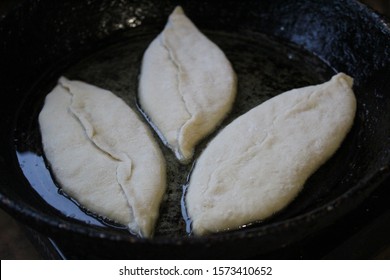  Photo Pies In The Pan.the Semi-finished Product Is Fried.dishes Cast Iron, Black.