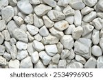 Photo of Pile of white pebble stones close up. Background texture for backdrops or mapping