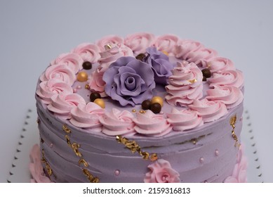 A photo of pink buttercream cake with buttercream frosting