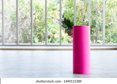 Photo Of Pink Yoga Mat Is Located Inside The Room.