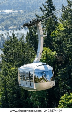 A photo of the Portland Aerial Tram transporting riders to a hilltop in Portland Oregon.